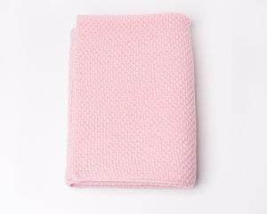 Nivas Cashmere Blend Baby Blanket, folded in pink on a light background, crafted with luxurious wool.