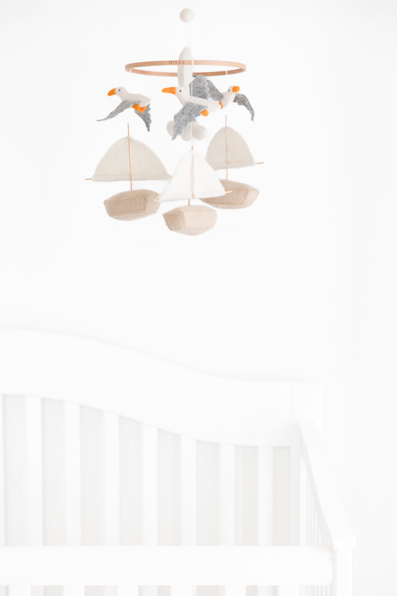 The Nivas Sailboat & Seagull Crib Mobile, with its delightful felt boats and seagulls, is the perfect baby shower gift for those embracing a nautical theme.