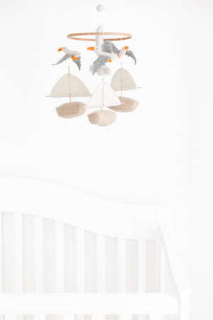 The Nivas Sailboat & Seagull Crib Mobile, with its delightful felt boats and seagulls, is the perfect baby shower gift for those embracing a nautical theme.