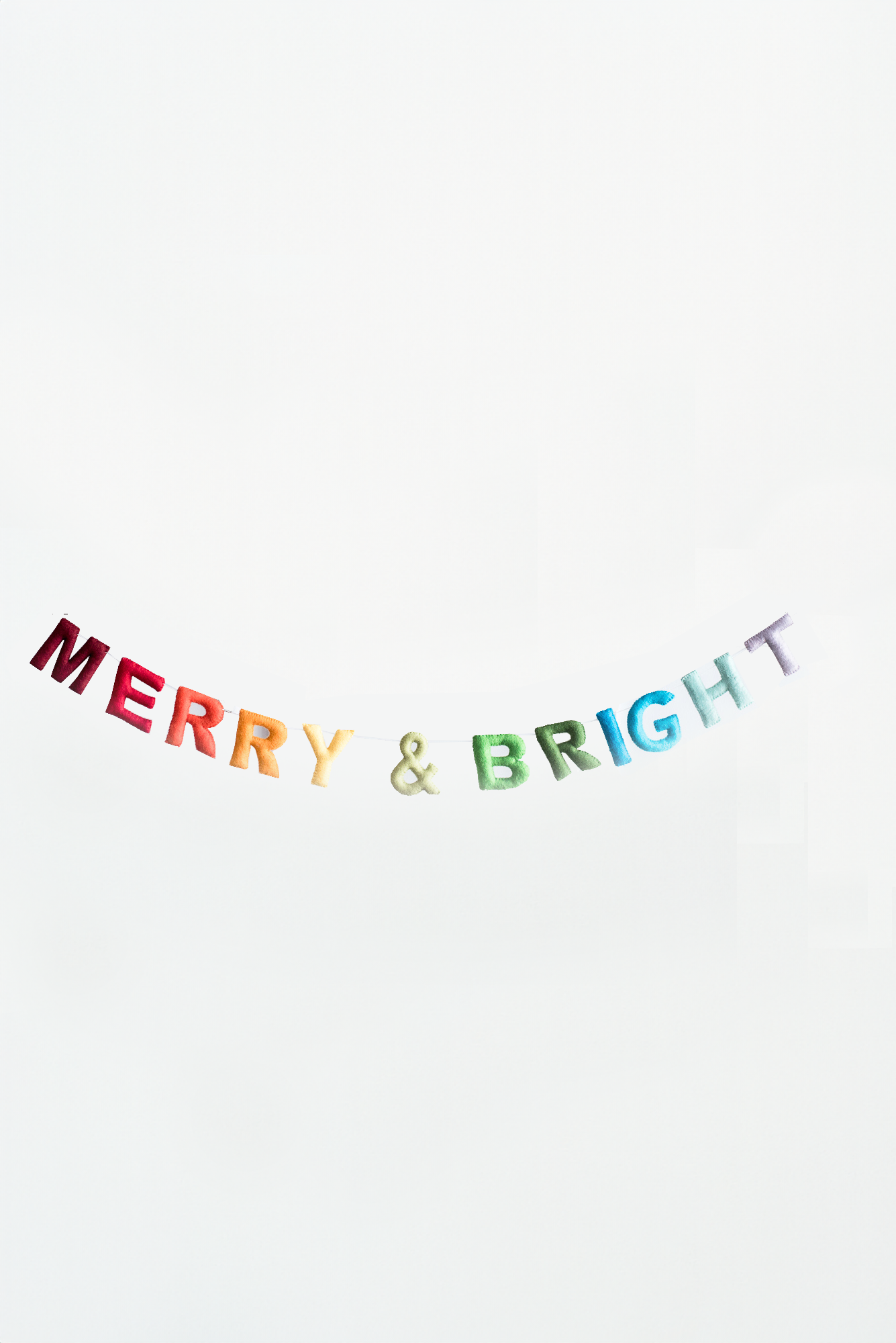 The Nivas Merry and Bright Garland spells out Merry & Bright in colorful felt letters against a plain white backdrop, bringing holiday cheer to any room.