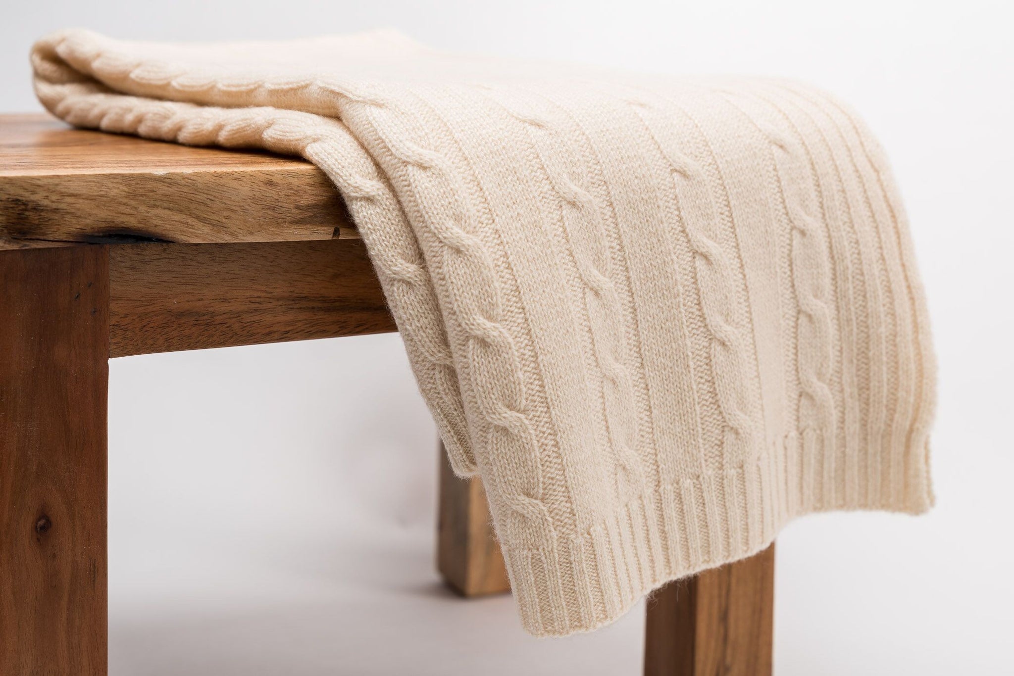 classic cashmere baby blanket, cableknit blanke, blanket on wood, handknitted, Nivas Collection